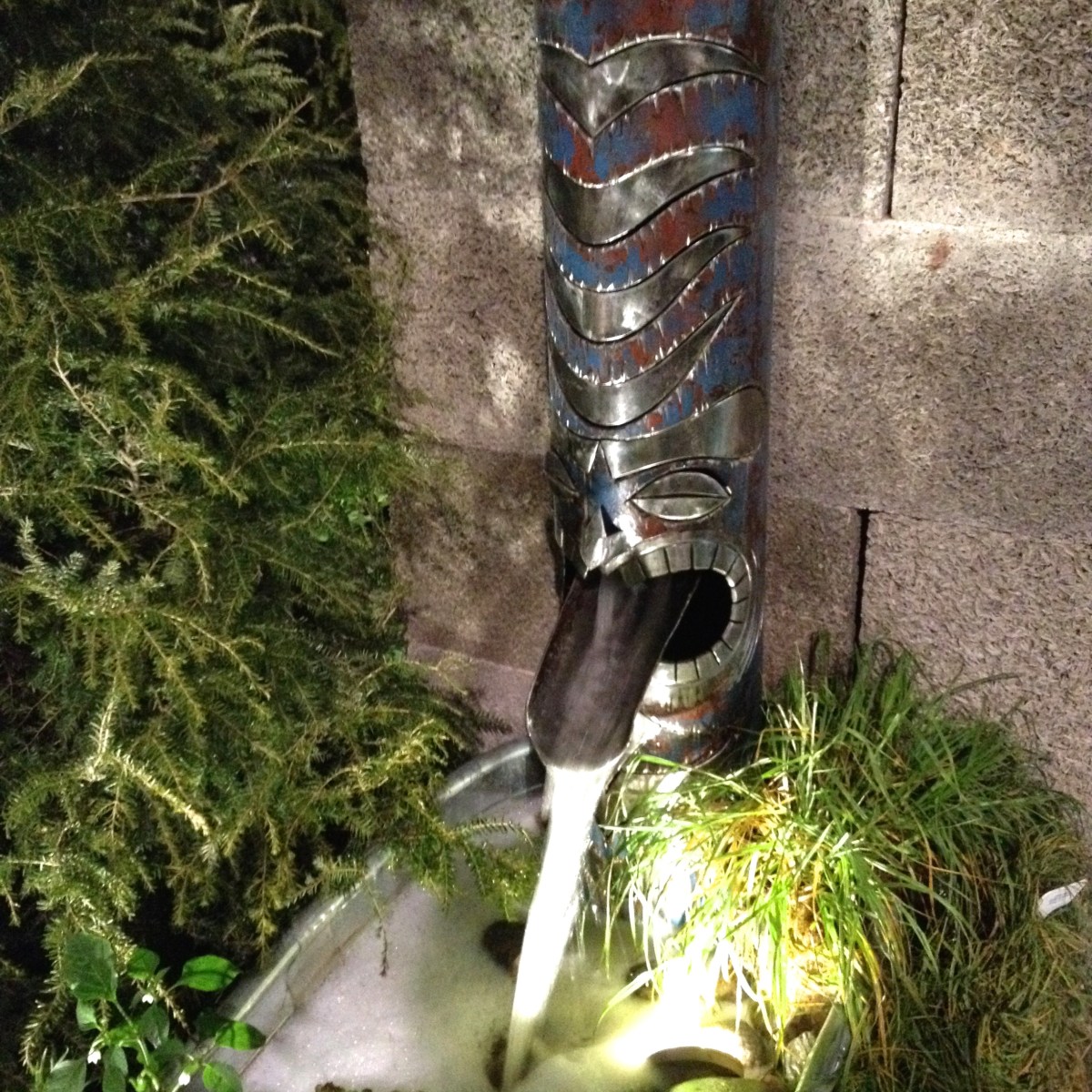 Carved metal downspout