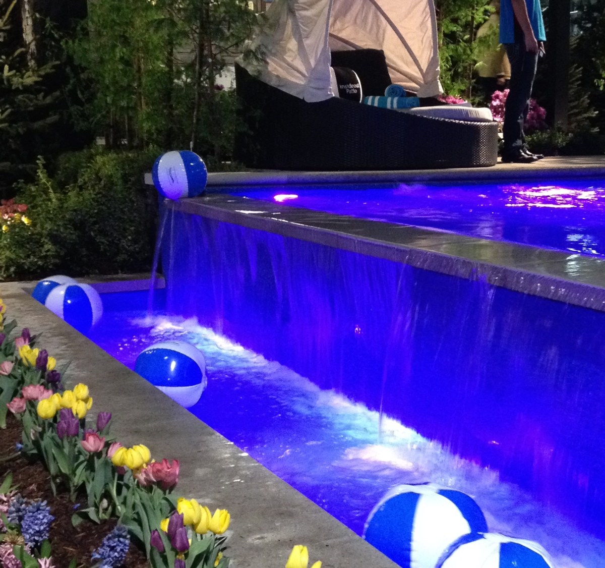 Pool with water feature lights up in bright colours.