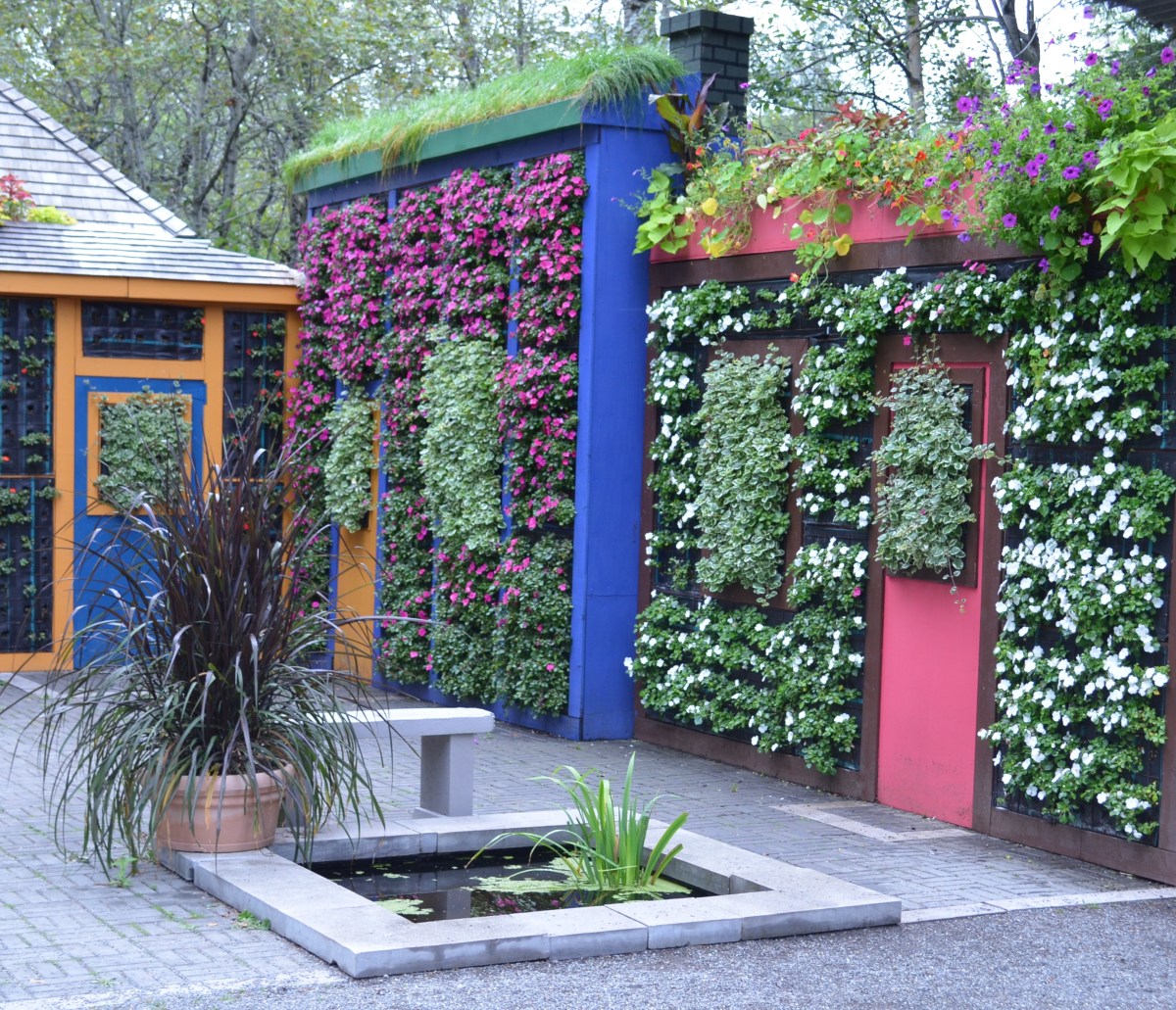 Walls resembling homes are covered with vertical garden installations.