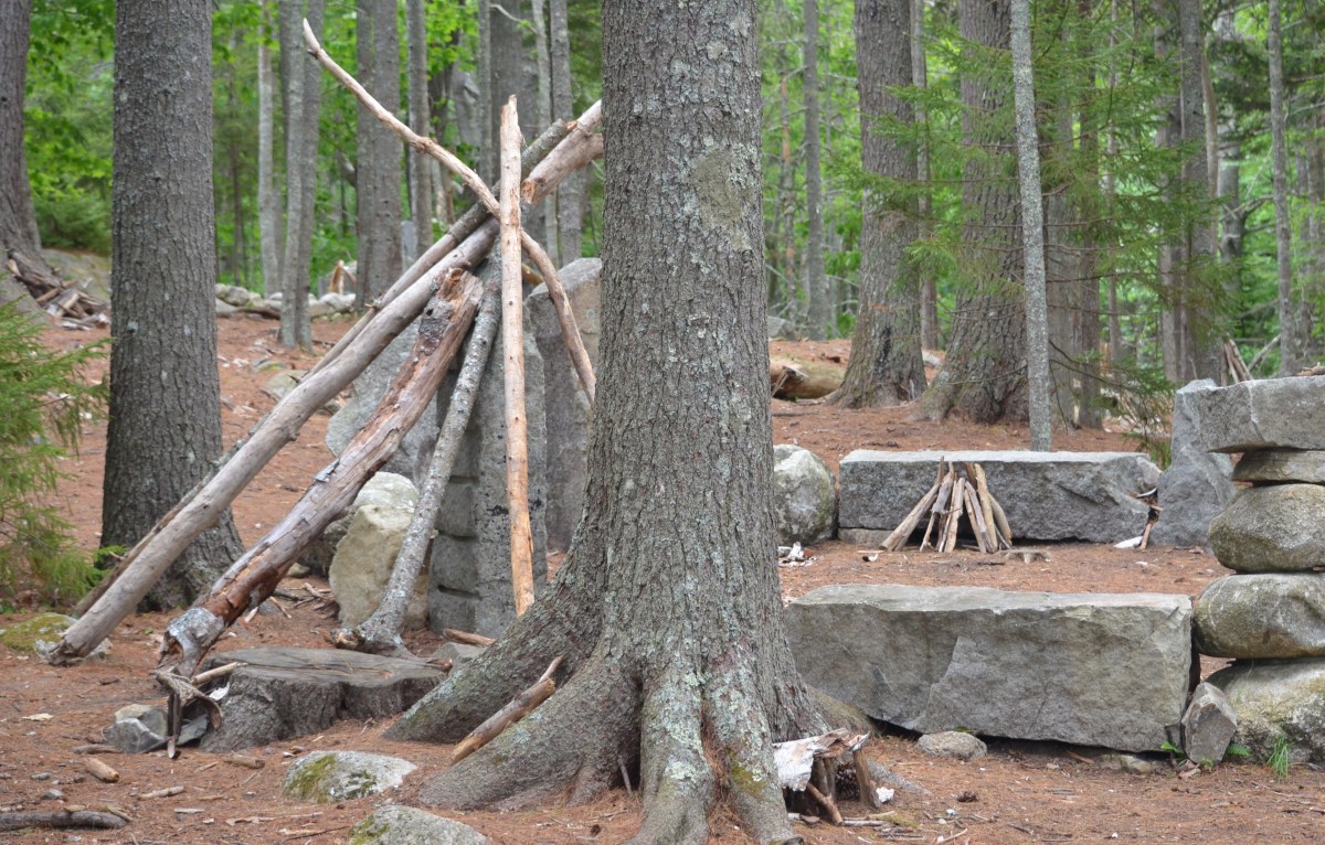 Temporary wooden structures made from found wood in a garden for children.