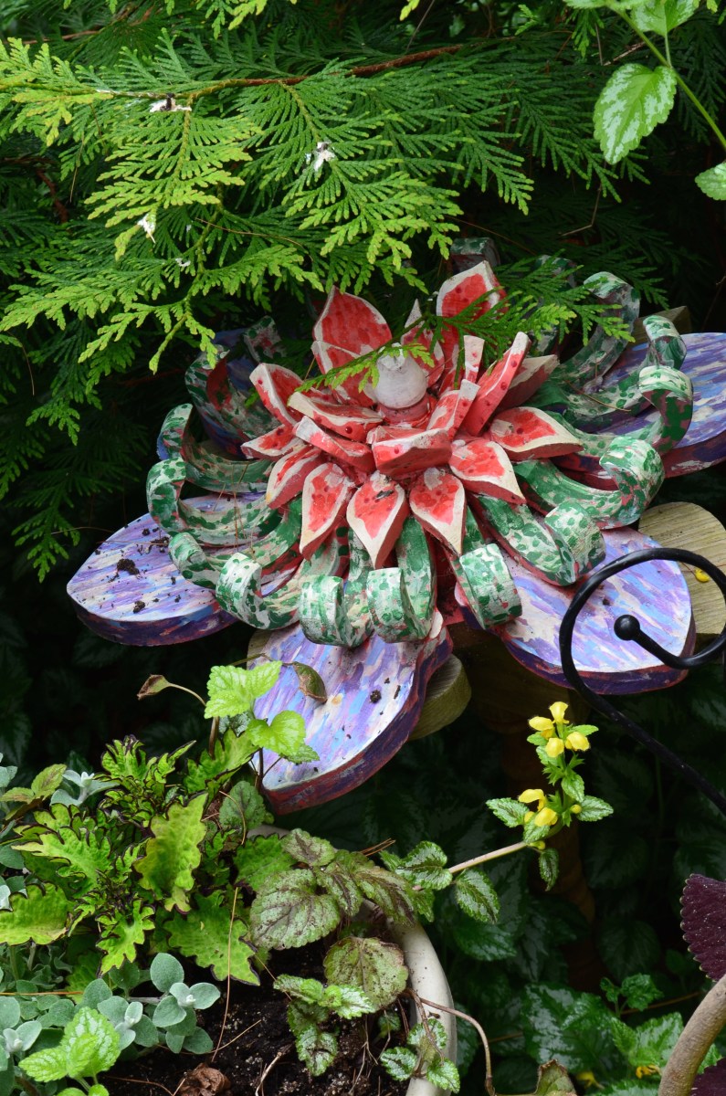 A carved flower in a garden.