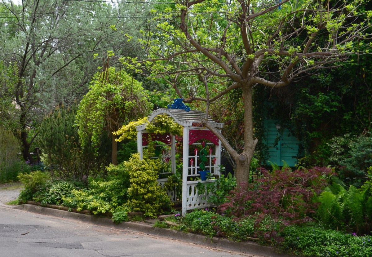 An ornate archway leads directly from the road to a back garden.