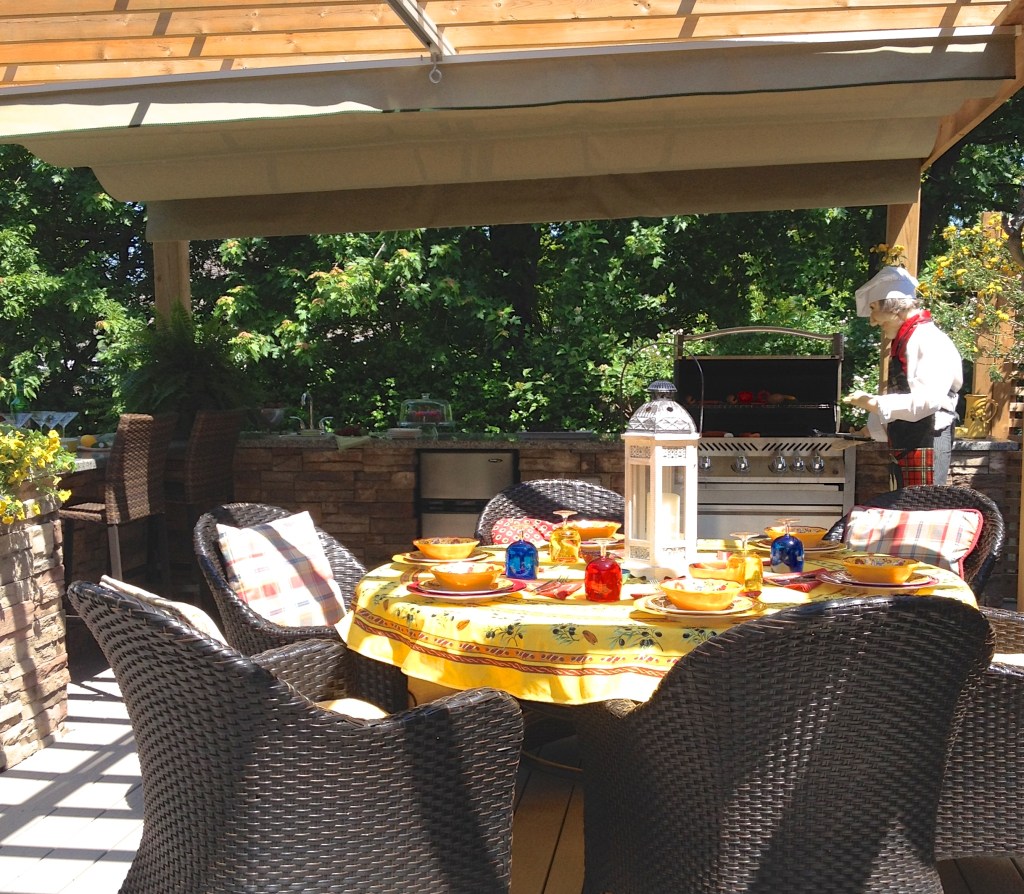 An outdoor kitchen under a pergola.
