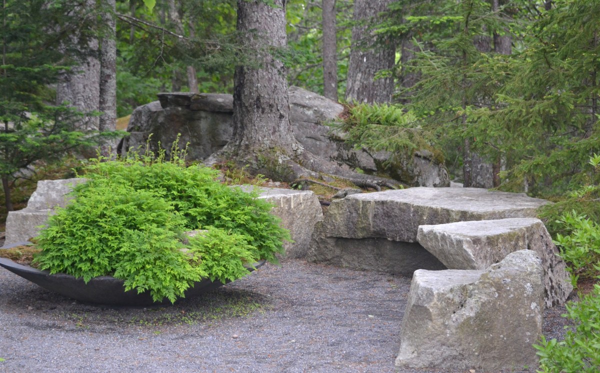 Stone seating looks naturalistic in a forest setting.