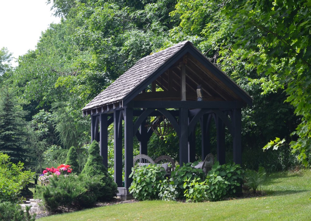 A wooden gazebo with chandelier