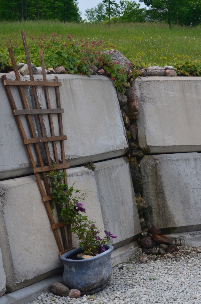 A close up of a retaining wall shows how the blocks are used to create a water feature.