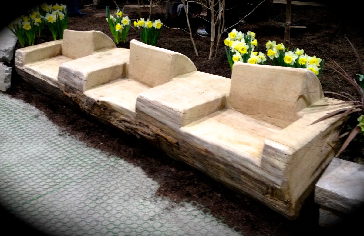 A huge log has been carved into seating for garden furniture.