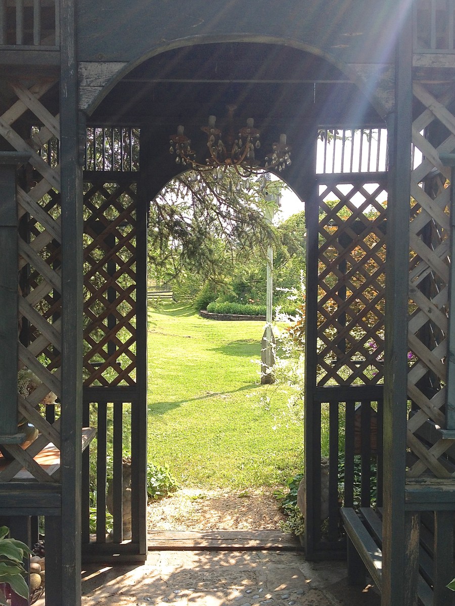A latticed archway provides garden seating.