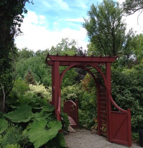 An ornamental gate leads into a lush garden at Lost Horizons