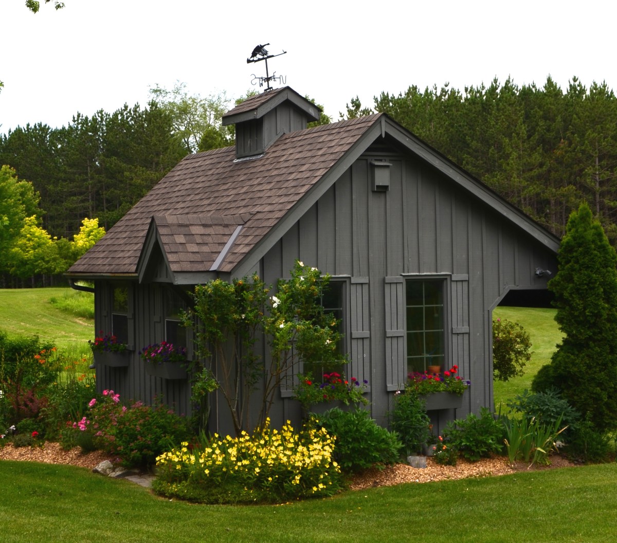 An adorable garden shed brings your attention back from the long views to meadow and forest.
