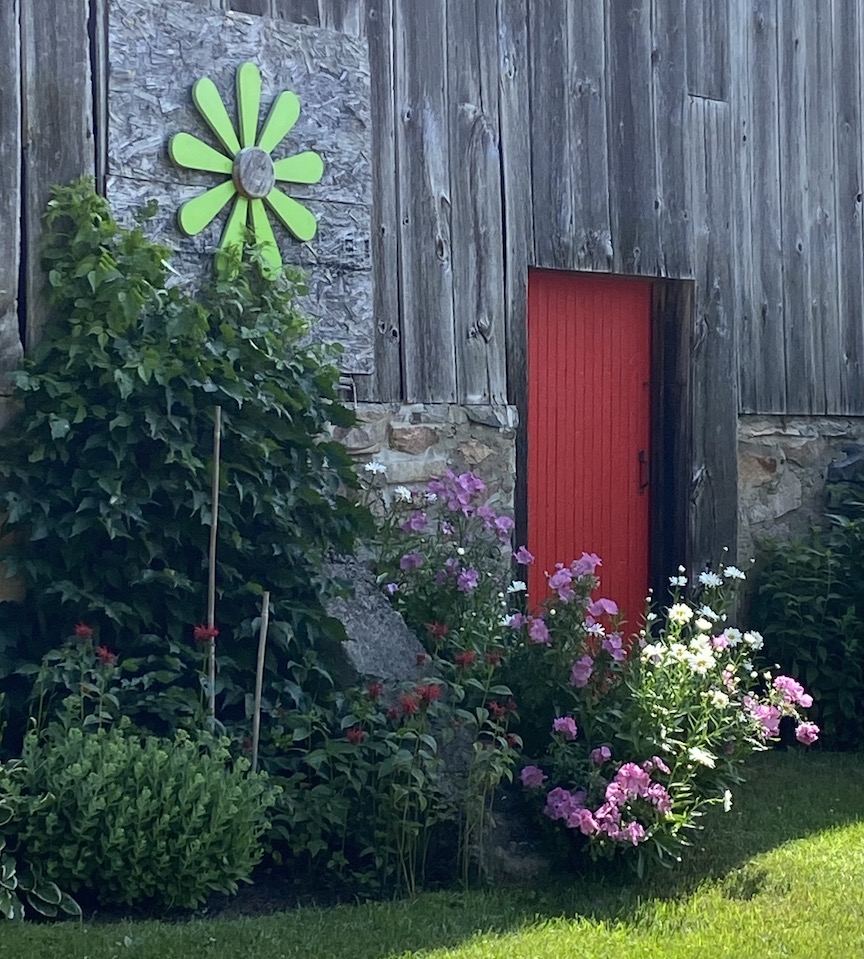 Barn with red door and flowers