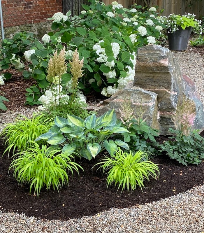 Rock in island flower bed