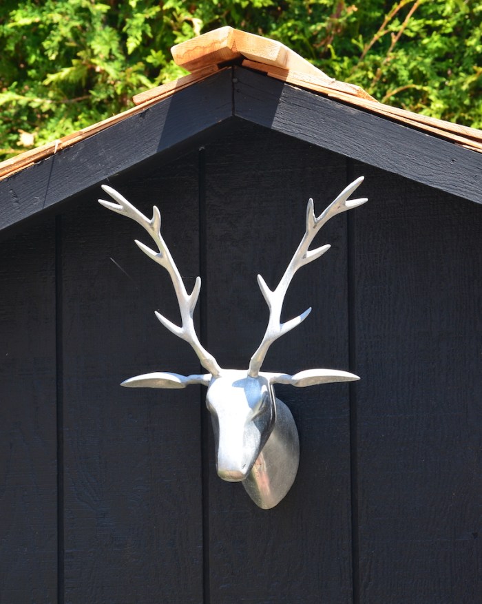 Metal moose head on garden shed