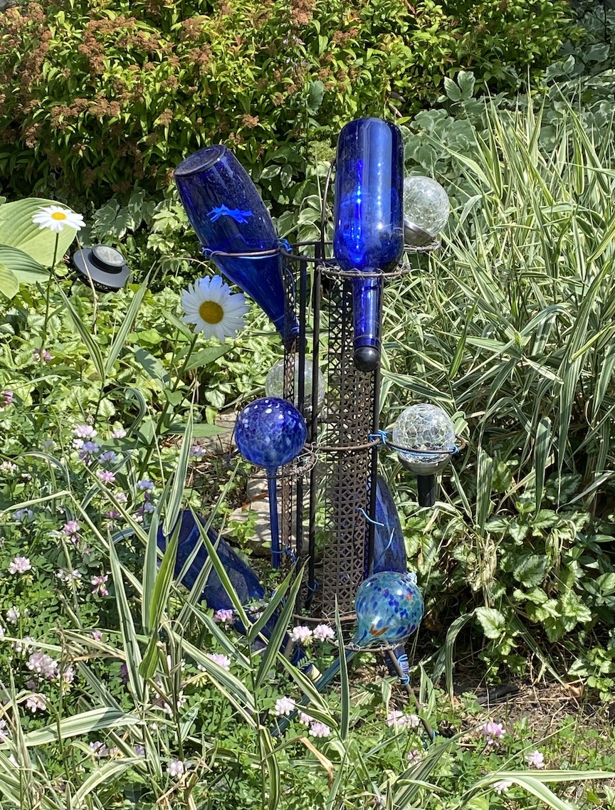 Blue wine bottles as garden decor