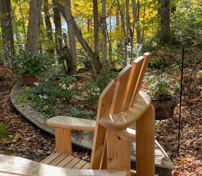 The autumn garden with wooden chair