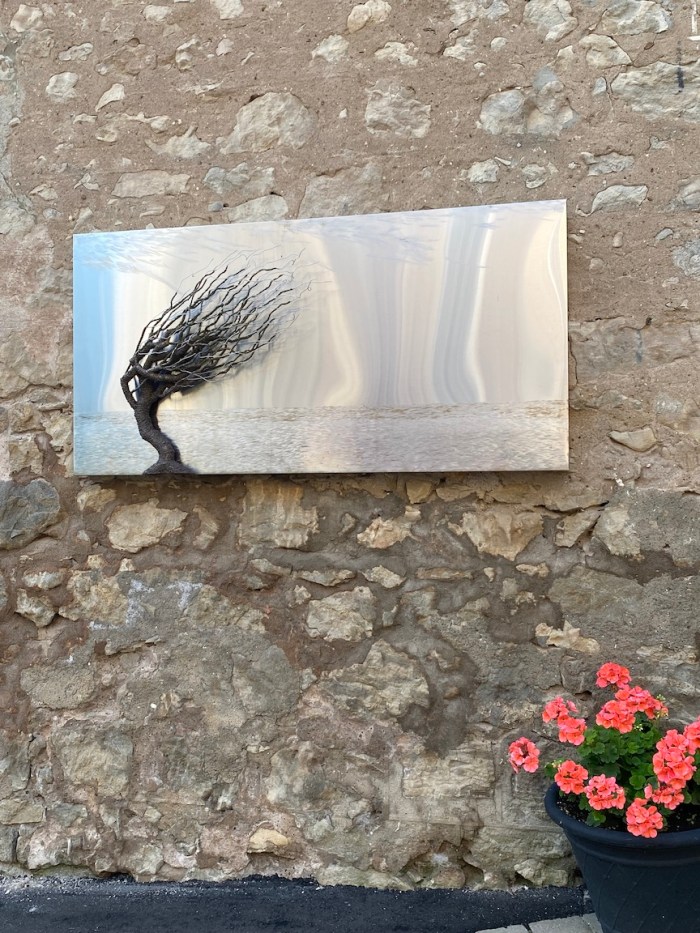 Steel art on garden wall