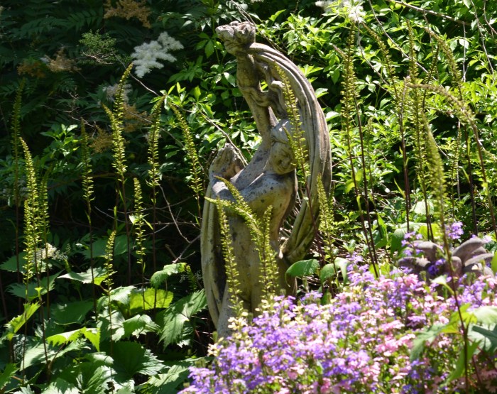 Sculpture with flowers in a garden