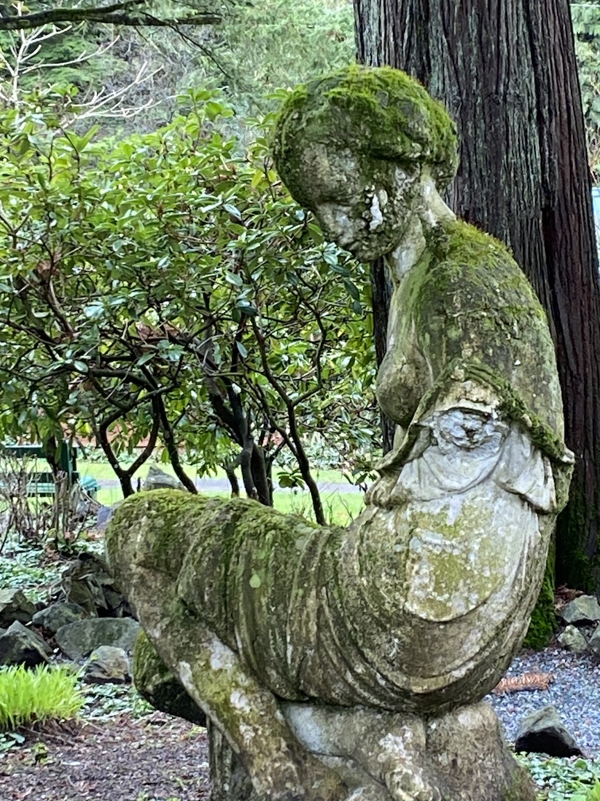 Moss covered garden sculpture